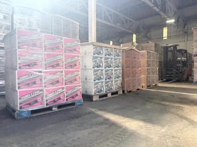 Pallets of finished product beside a forklift on the warehouse floor